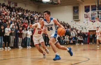 When Does High School Basketball Season Start? 2026–27 Season Dates by State High school basketball player driving to the basket during the first game of the 2026–27 season in a packed gym.